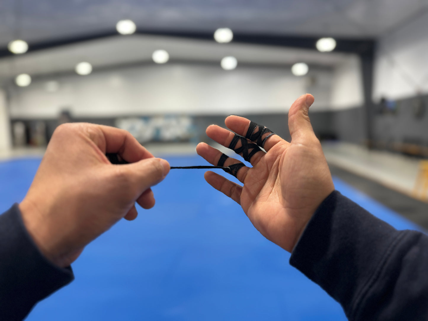 Black finger tape on grappler's hands